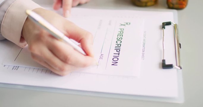 Female Doctor Holding Pill Bottle And Writing Rx Prescription 4K