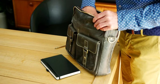 Businessman Is Finishing Work And Packing His Briefcase