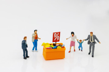 Miniatrue people: Shoppers buy goods on sale with discount tray. Tourism, shopping or business concept.