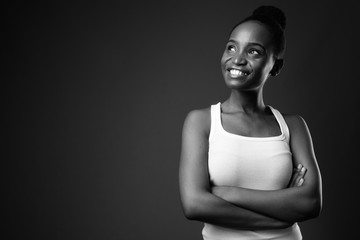 Obraz premium Young beautiful African Zulu woman smiling and thinking in black and white