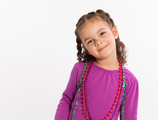 Cute, smiling, mixed race girl with Mardi Gras beads, isolated on white backgroun