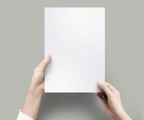 Close up hands holding blank paper for work at desk office top view. clipping path, Isolated.