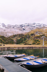 Trubsee lake row boats with Swiss Alps of Engelberg