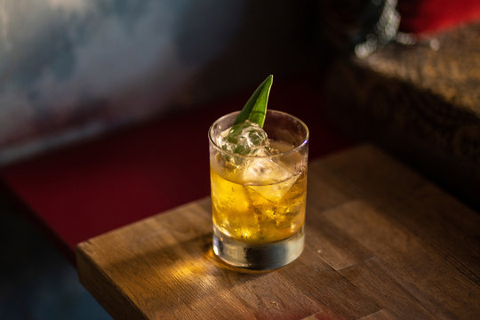 High angle view of alcohol served in drinking glass on wooden table