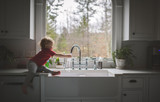 Side view of girl washing hand in sink