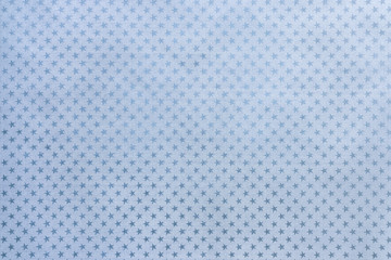 Light blue background from metal foil paper with a stars pattern