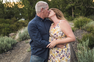 Mature couple kissing in forest