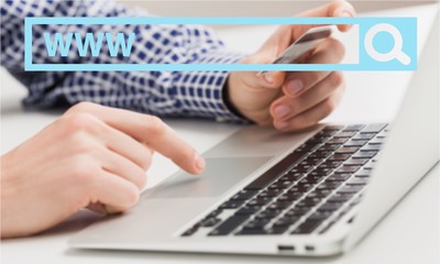 Man holding a credit card and typing. On-line shopping on the