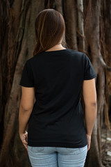 Woman wearing black t shirt in back side view in outside, ready for your mock up design template or...