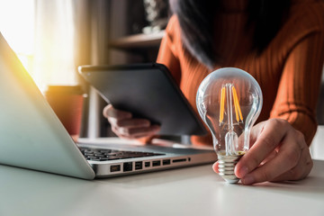 Business women entrepreneurs show creative business strategies with light bulbs as a concept. On...