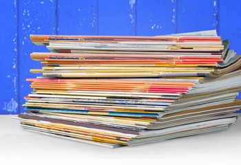 Pile of newspapers on white background