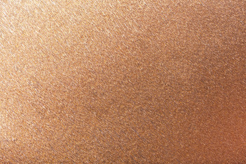 Textural of bronze background of wavy corrugated paper, closeup.
