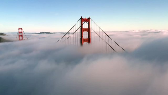 San Francisco Golden Gate Bridge Sticking / Poking Through Thick blanket of Fog - Aerial View / Flyover From Helicopter