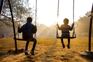children swing on a swing in Delhi Park