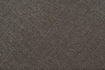 Textural of dark brown background of wavy corrugated paper, closeup.