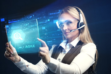 The concept of business, technology, the Internet and the network. A young entrepreneur working on a virtual screen of the future and sees the inscription: Agile