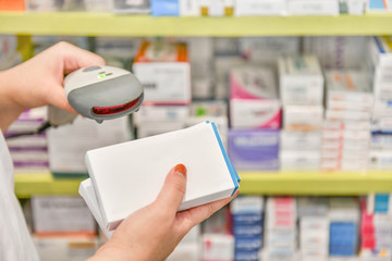 Pharmacist scanning barcode of medicine drug in a pharmacy drugstore