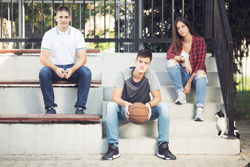 Obraz na płótnie Canvas Three teenagers sitting