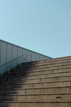 Low angle view of empty steps against clear blue sky during sunny day