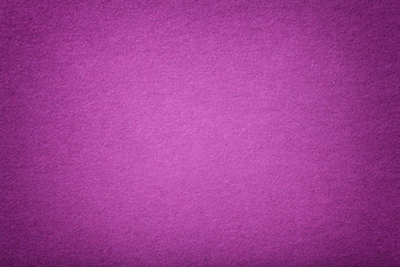 Dark purple matt suede fabric closeup. Velvet texture of felt.