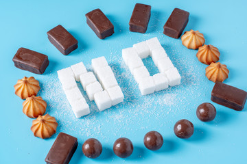 Text No is lined with sugar cubes with sweets and cookies. Harm to the health of sweet and rejection of sucrose