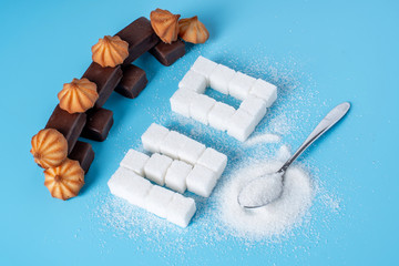 Text No is lined with sugar cubes and sweets. Harm to the health of sweet and rejection of sucrose