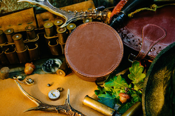 Closeup round hunt box for information among hunting or tourist equipment. 