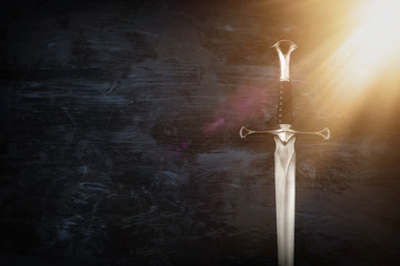 low key image of silver sword. fantasy medieval period.