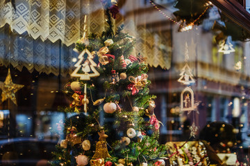 Vienna, Austria - December 21, 2017. Showcase with christmas tree decoration and lighting garlands by wintertime. Glass display with xmas ornaments and lights.