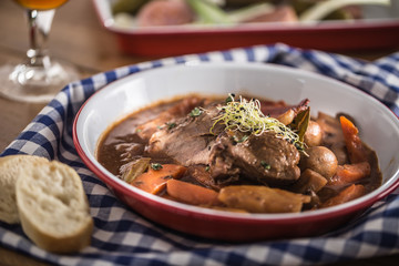 Roast wild boar with carrot mushrooms, baguette and draft beer