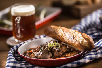 Roast wild boar with carrot mushrooms, baguette and draft beer
