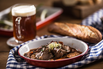 Roast wild boar with carrot mushrooms, baguette and draft beer - obrazy, fototapety, plakaty