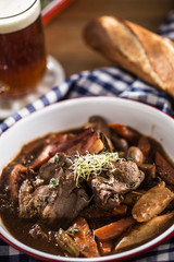 Roast wild boar with carrot mushrooms, baguette and draft beer