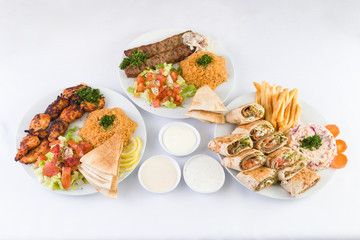 Chicken Kabab, Beef Kafta Kabab, and Arabic Gyro Beef Shawerma with sauces on the  table - 238497391