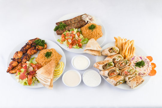 Chicken Kabab, Beef Kafta Kabab, and Arabic Gyro Beef Shawerma with sauces on the  table