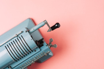 Old counting machine on pink background