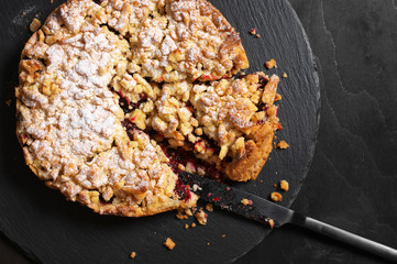 Homemade round fruit pie on slate dish