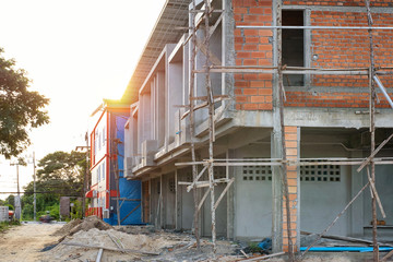 Fototapeta na wymiar two storey houses are under construction in Thailand, modern house design. House construction. with sun light