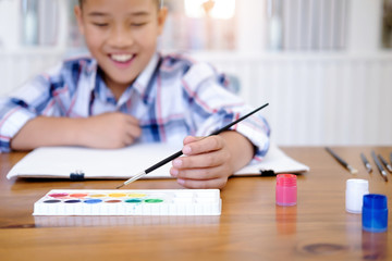 Child boy drawing picture at home.