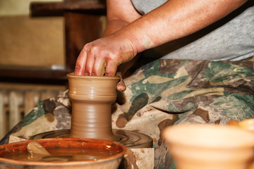 Hands of Potter man sculpt something by clay in a craft workshop