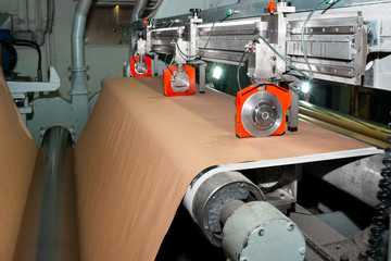Paper production producing packaging paper and cardboard from waste paper. Pneumatic knives for cutting roll materials. Industrial equipment, paper machine