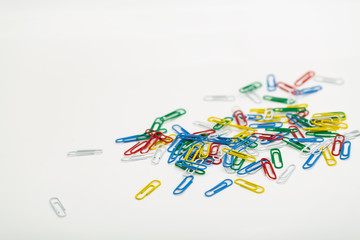 Colored paper clips isolated on white background.