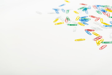 Colored paper clips isolated on white background.