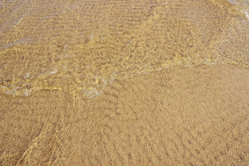 Fototapeta na wymiar Ripples over the sandy bottom