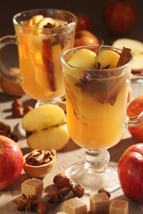 Two cups with hot cider in cold season with cinnamon and anise