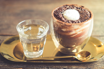 Black coffee or Americano on table with film vintage tone background.