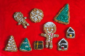 Gingerbread man cookie biscuits Christmas decoration pattern on red background, Christmas tree decorating edible for party or Happy New year celebration holiday,homemade bakery, Copy space for design.