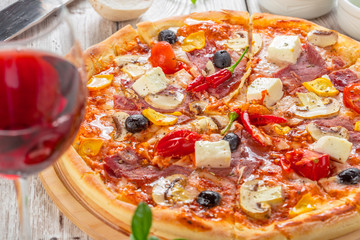 Pizza with Mozzarella, Ham, Cherry Tomatoes, Black Olives