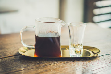 Black coffee or Americano on table with film vintage tone background.
