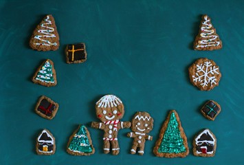 Christmas homemade gingerbread cookies on green background. copy space.